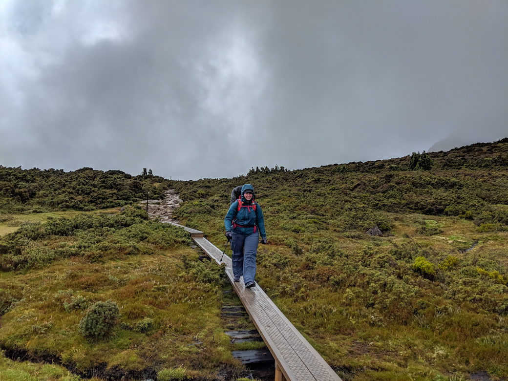 A hiker walks along a boardwalk on the Overland Track in Tasmania. It is raining and she wears a rain jacket and rain pants. Why do rain jackets wet out?
