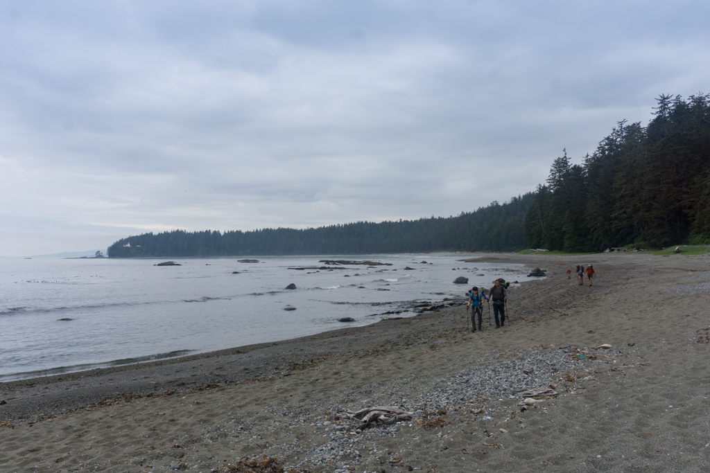 Hikers walk through soft sand near Carmanah River on the West Coast Trail