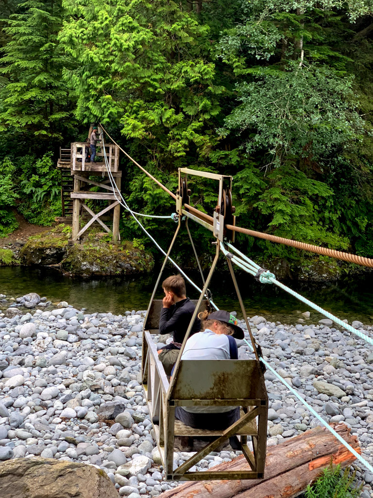 Two hikers ride the Camper Creek cable car on the West Coast Trail