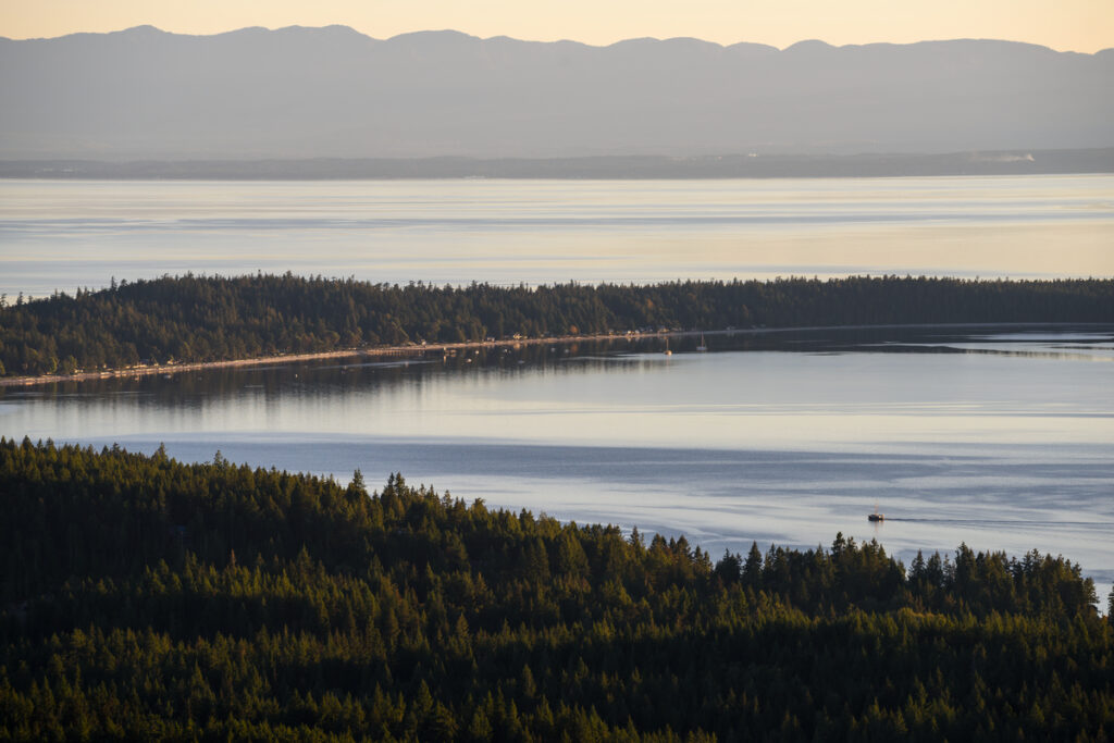 Looking down to the sandy beaches of Savary Island from Manzanita Bluff on the Sunshine Coast Trail.