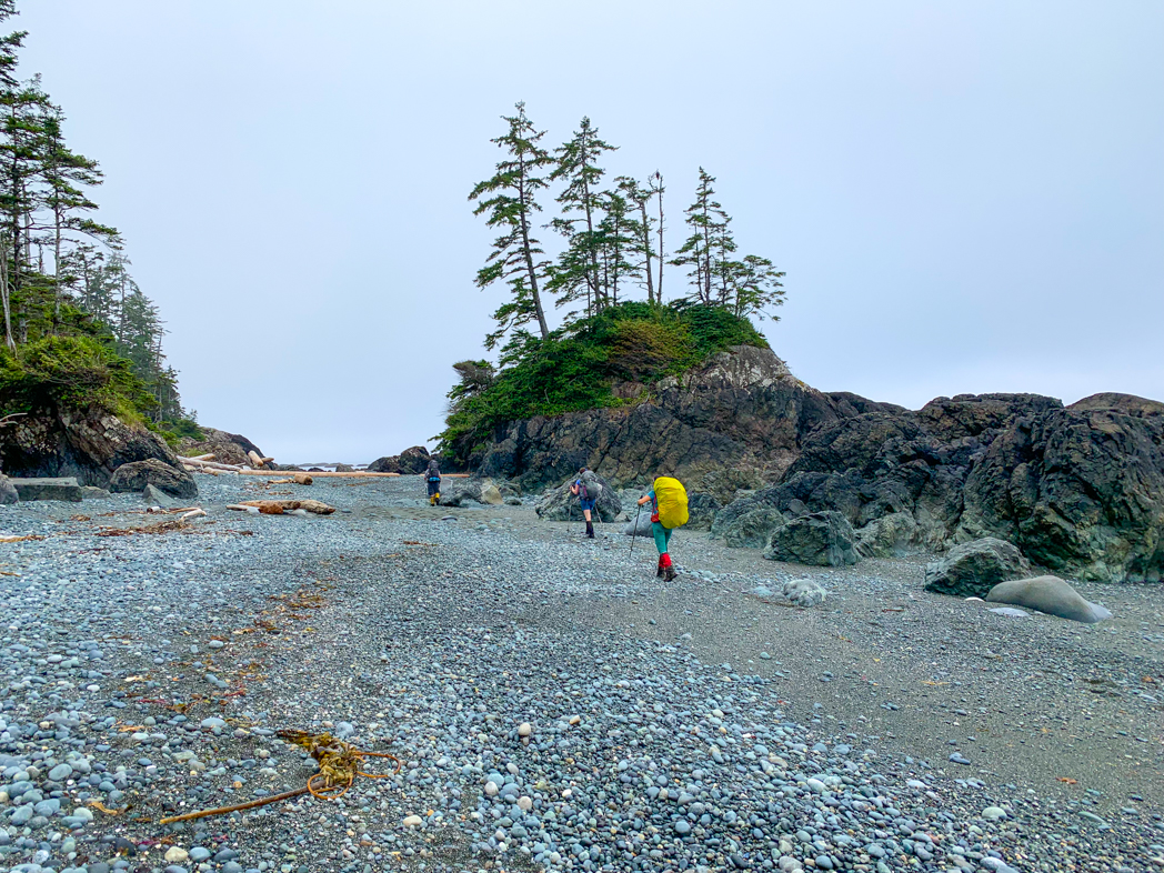 Hikers on the beach near Cape Sutil on the North Coast Trail. Day 3 of the North Coast Trail itinerary