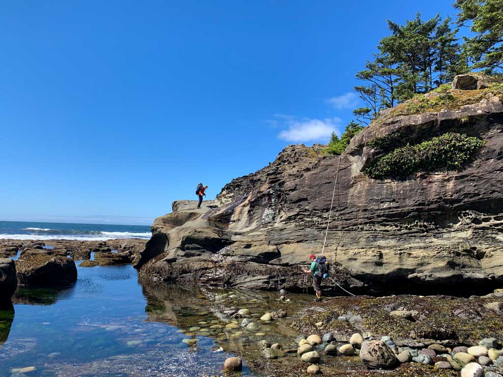 Scrambling up a cliff on the Tatchu Trail
