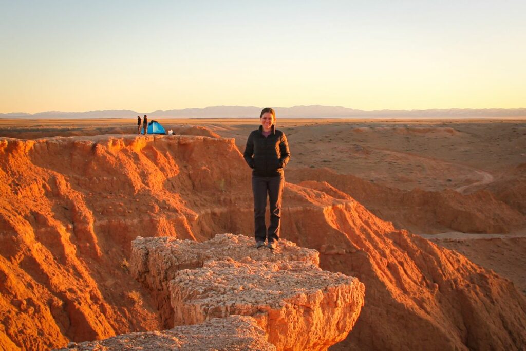 A woman wearing prAna Halle II pants (the best women's hiking pants) poses in the Gobi dessert
