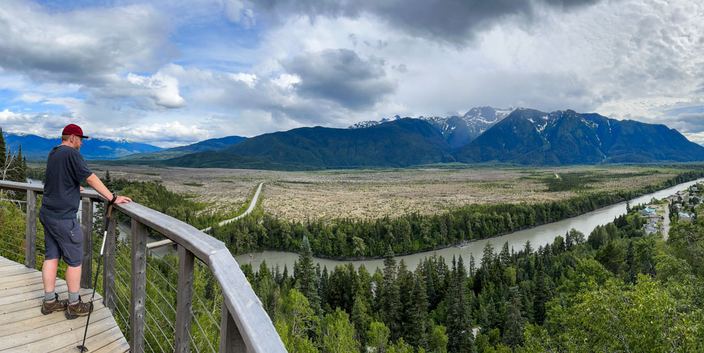 A man stands on the Saasak'Viewing Platform in the Nass Valley