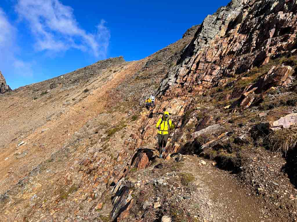 Hikers walk across rocks on the Huber Ledges