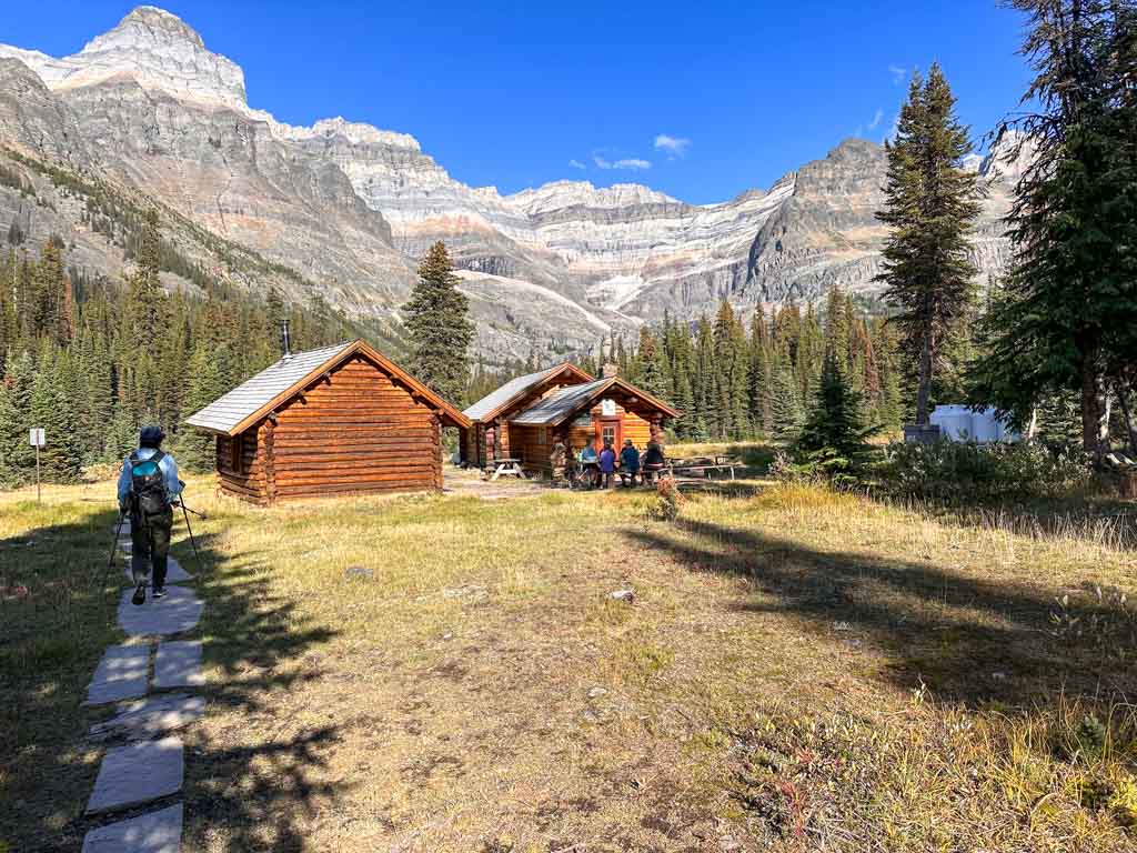 A hiker walks past the Elizabeth Parker Hut at Lake O'Hara