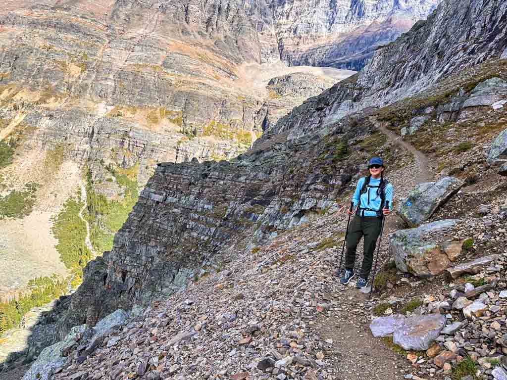 A female hiker walks along a rocky trail on the Lake O'Hara Alpine Circuit