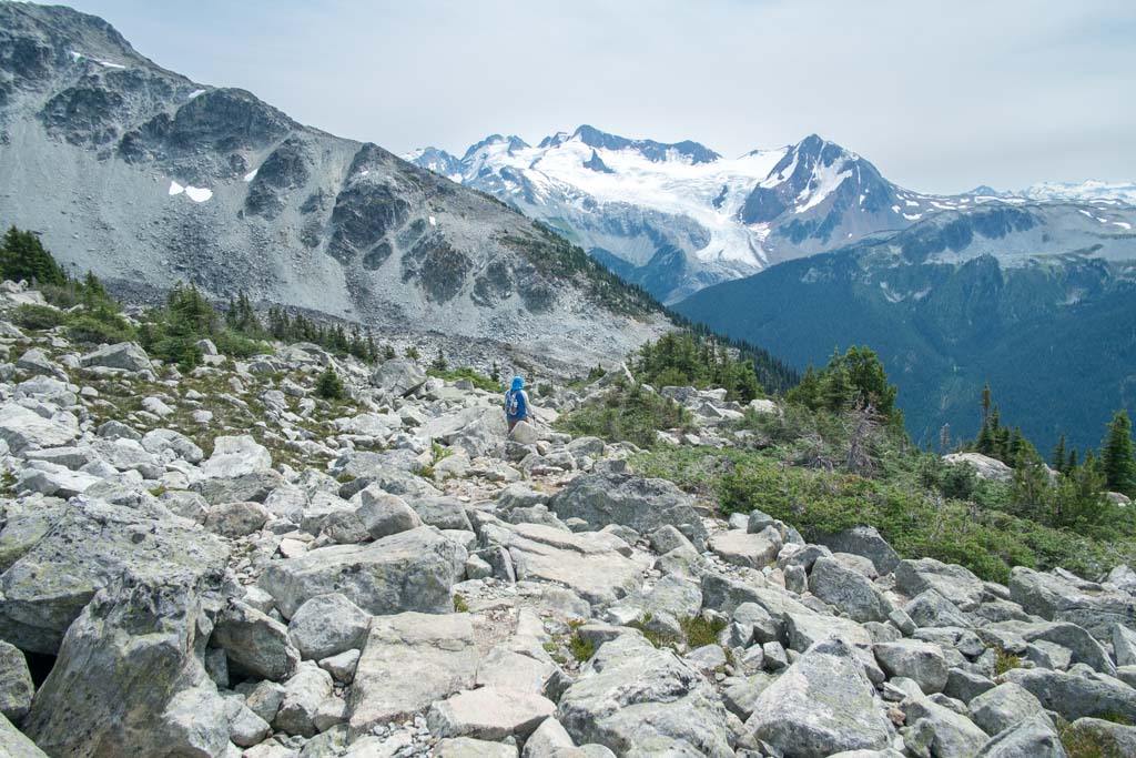 Walking downhill through the rocks towards Decker Tarn on Blackcomb Peak