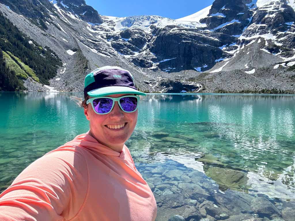 A hiker wearing a Ciele hat takes a selfie at Joffre Lakes