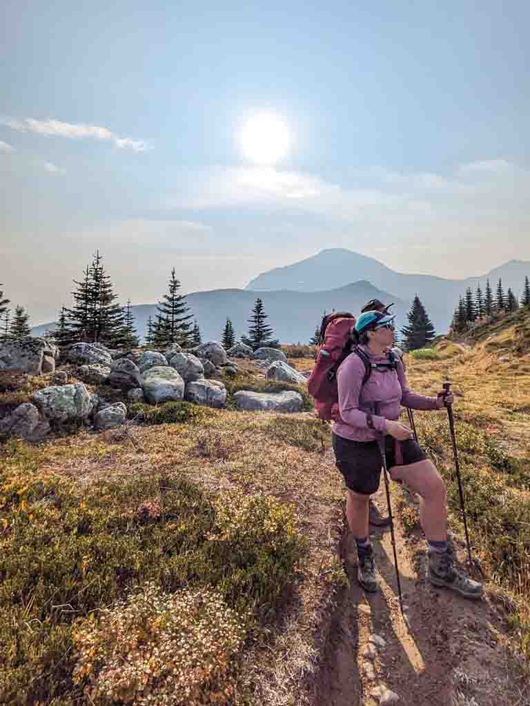 A hiker wears a sun hoodie on a backpacking trip
