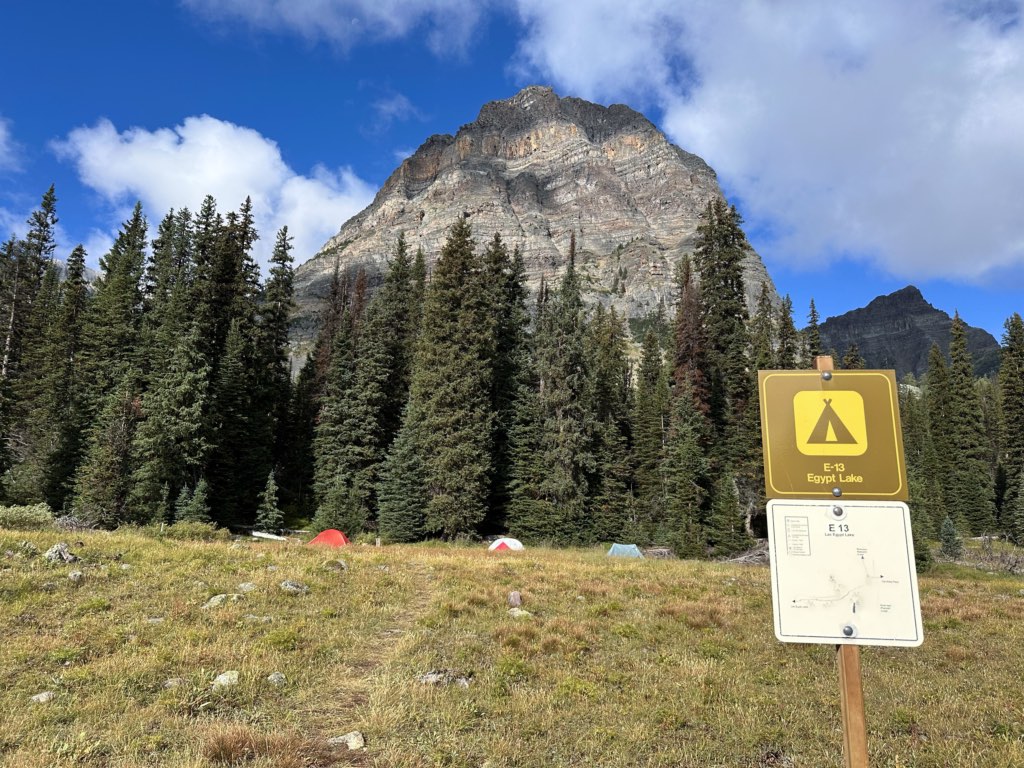 Tents in the Egypt Lake Campground with a sign in the foreground.