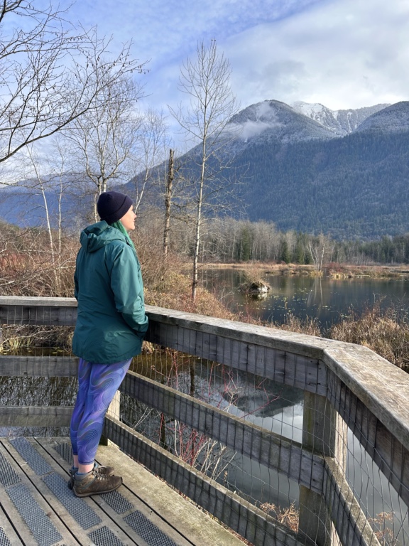 A woman wearing a green rain jacket at the Cheam Lake Wetlands