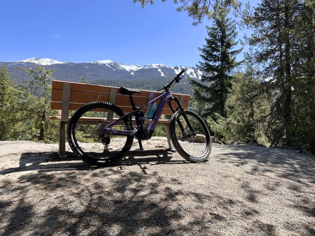 A bike leans against a bench on the Lost Lake mountain bike trails in Whistler