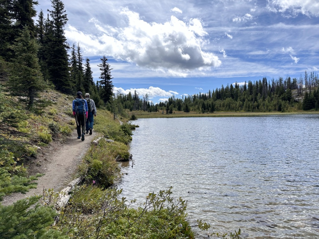 Hikers beside Grizzly Lake at Sunshine Meadows