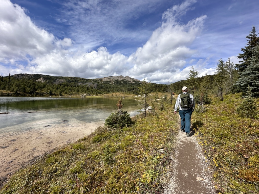 A hiker next to Laryx Lake