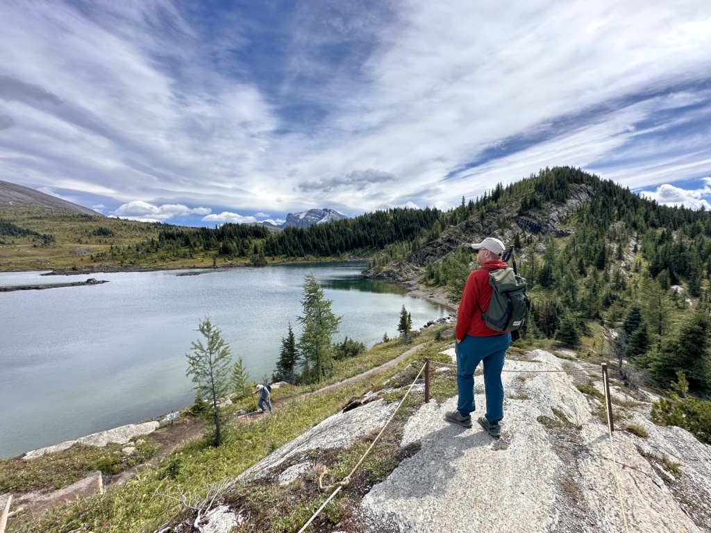 A hiker on a bluff viewpoint above Rock Isle Lake
