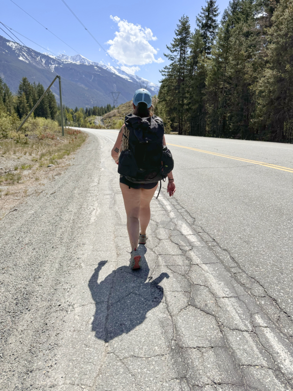 A hiker walking along Highway 99