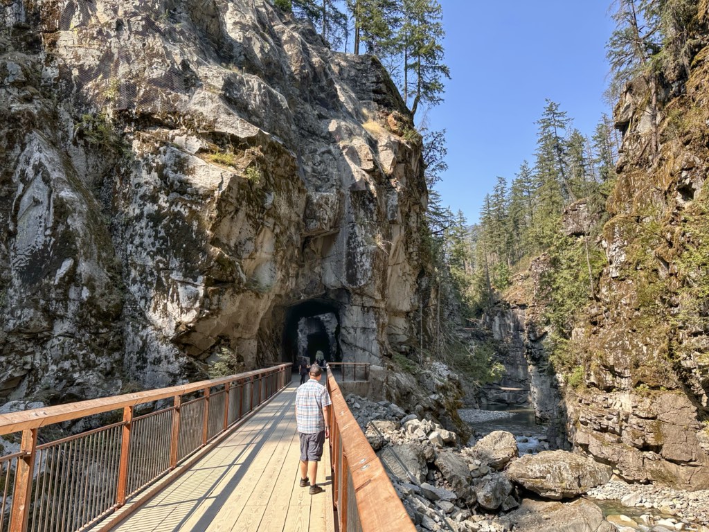 A man stands on a bridge at Othello Tunnels in Hope, BC