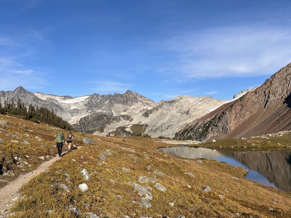 Two hikers walking along the trail to Russet Lake near Whistler