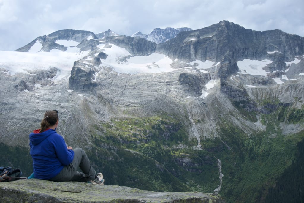 A hiker enjoys the view on the Glacier Crest Trail in Glacier National Park