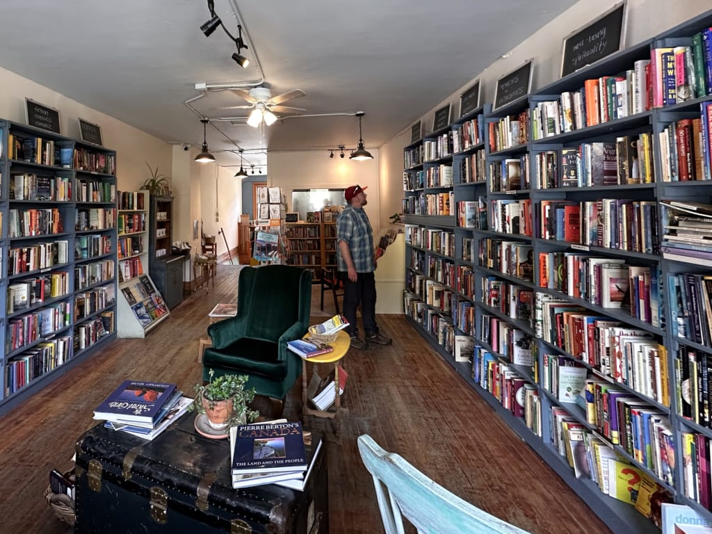 A man browses at Four Point Books in Golden, BC