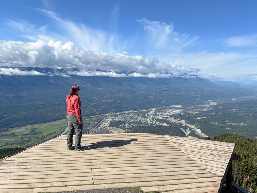 A woman stands on a viewing platform on top of Mount 7 in Golden, BC