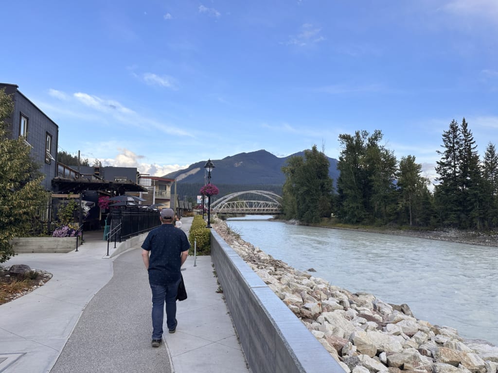 A man walks along the River Walk pathway in Golden, BC