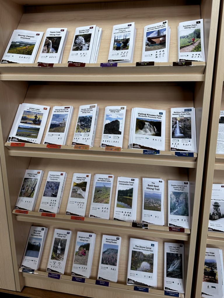 Rows of hiking brochures at the Tumbler Ridge Visitor Centre